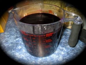 Elder Berry Syrup process Elder Juice in measuring Cup